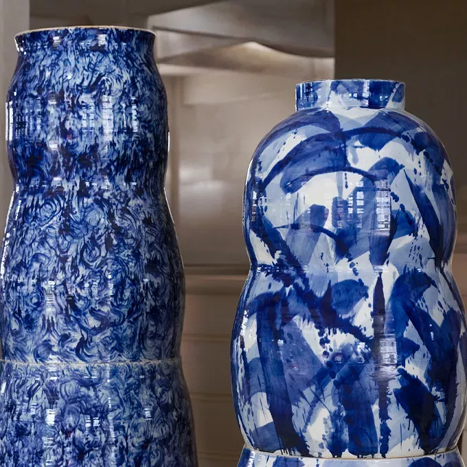 Two monumental ceramic pots with a blue patterned glaze.