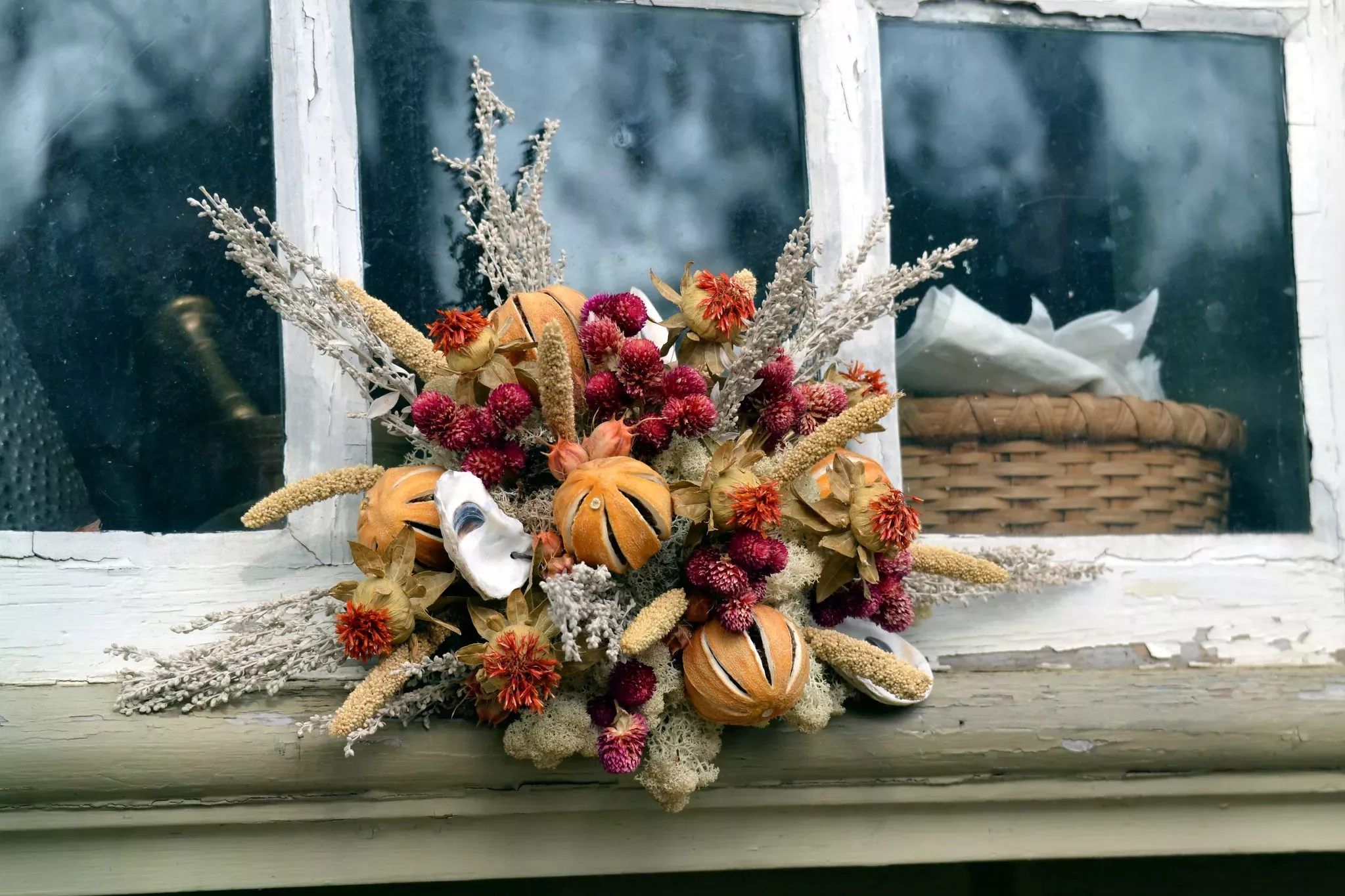 "Wreath (Window Dressing)" by Tobyotter is licensed under CC BY 2.0. Christmas dried flower decoration made with dried orange peel and other plants