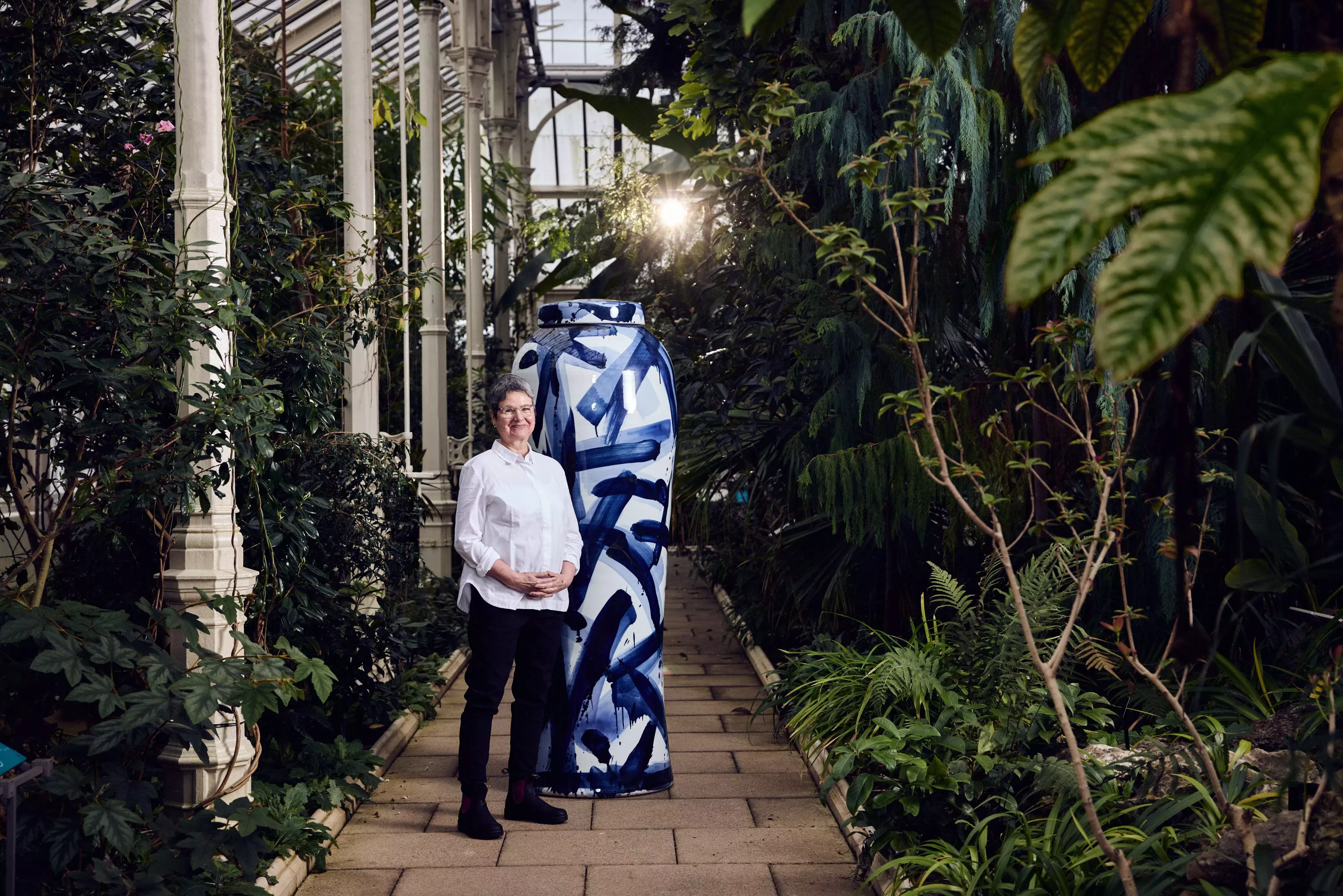 Image courtesy of Adrian Sassoon, London. Photography by Alun Callender Artist Felicity Aylieff standing next to one of her person-sized porcelain vases