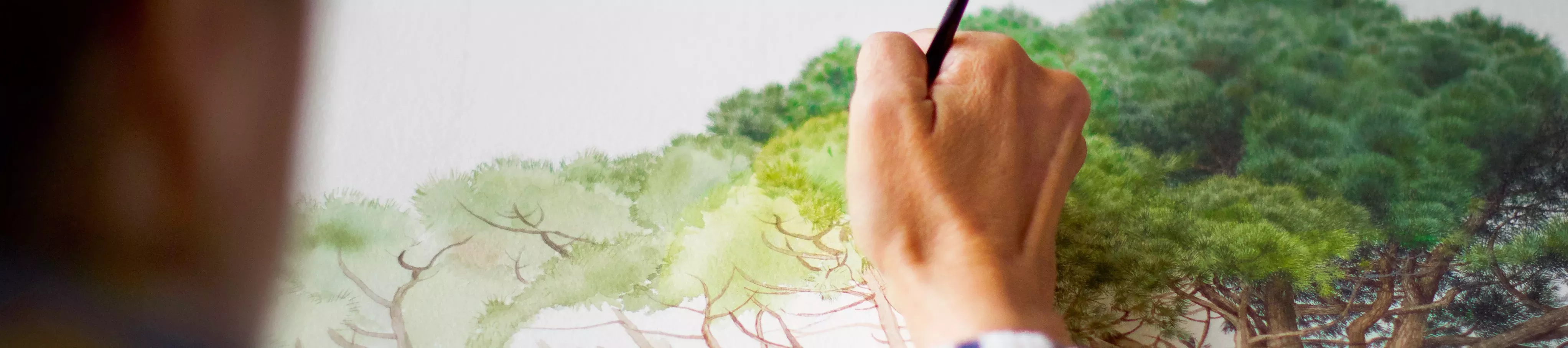 Close up of artist painting a tree on paper