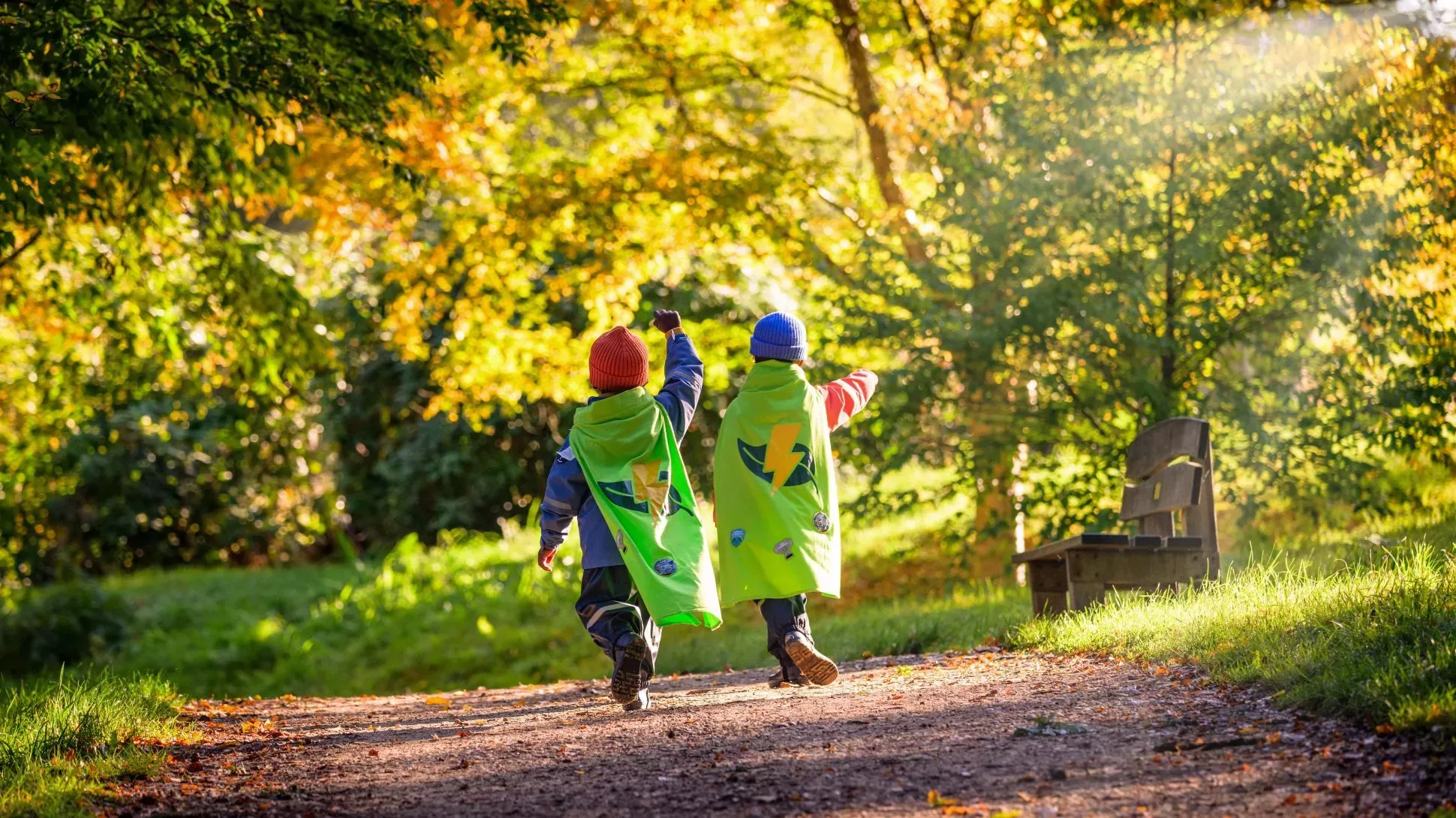 Nature Heroes at Wakehurst, Jim Holden © RBG Kew Two children in capes running through an autumnal landscape