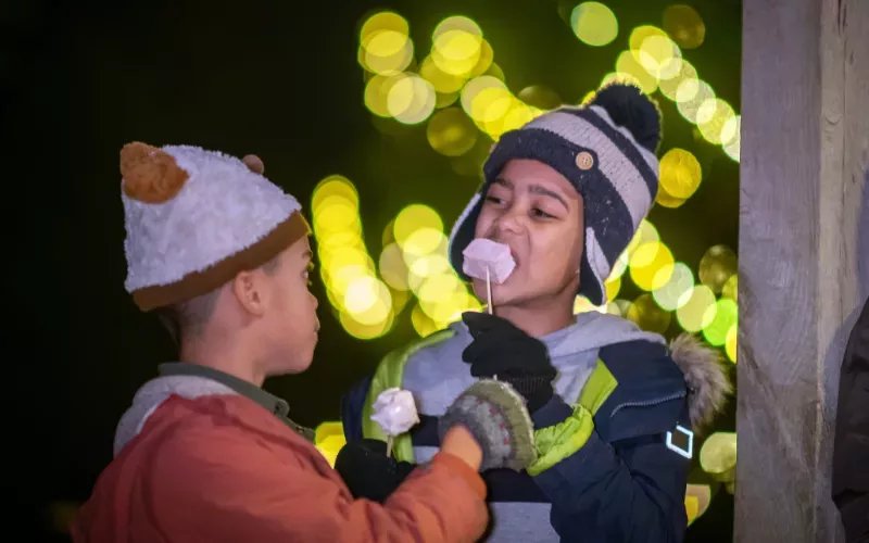 Two boys eat marshmallows at Glow Wild Two boys eat marshmallows at Glow Wild