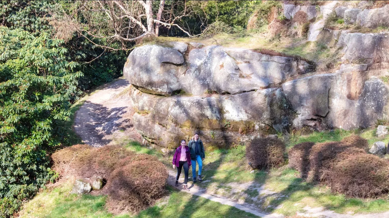 Himalayan Glade at Wakehurst © RBG Kew A pair of people walk through a rocky landscape