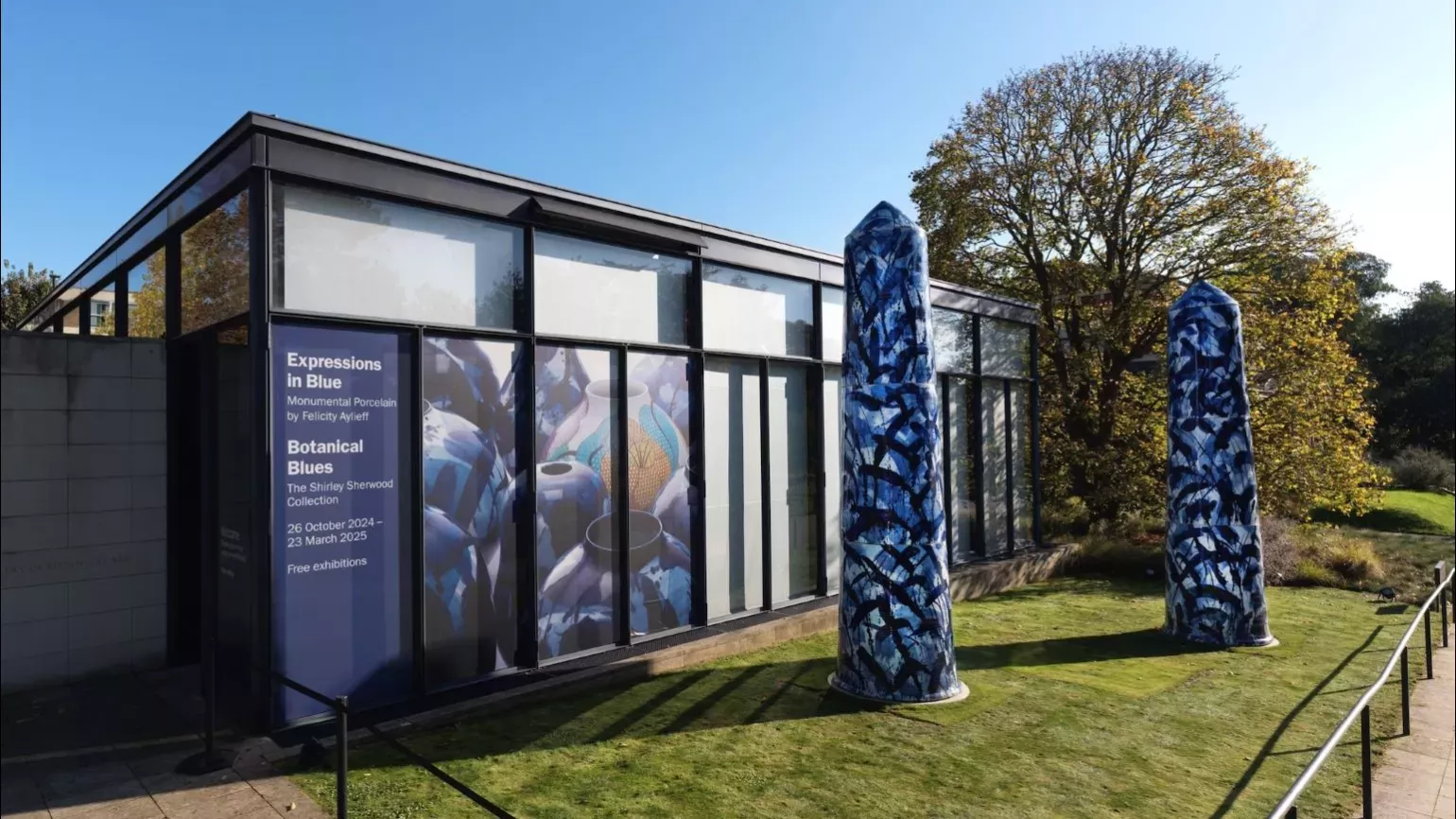An outside view of The Shirley Sherwood Gallery with two monumental ceramic pots in the foreground.