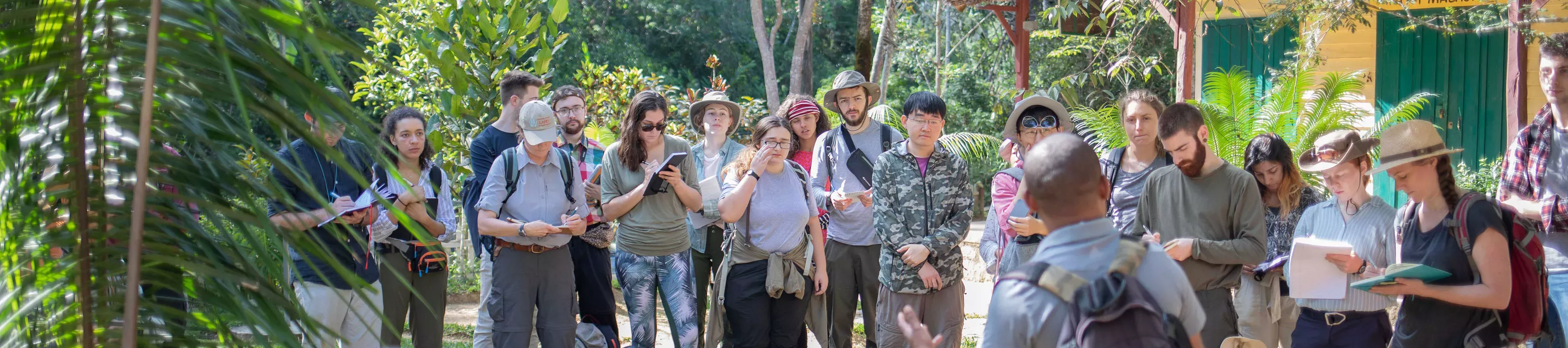 MSc Plant and Fungal Taxonomy fieldtrip © David Rabehevitra/RBG Kew MSc students on the Madagascar fieldtrip stood in a line looking at researcher giving a talk
