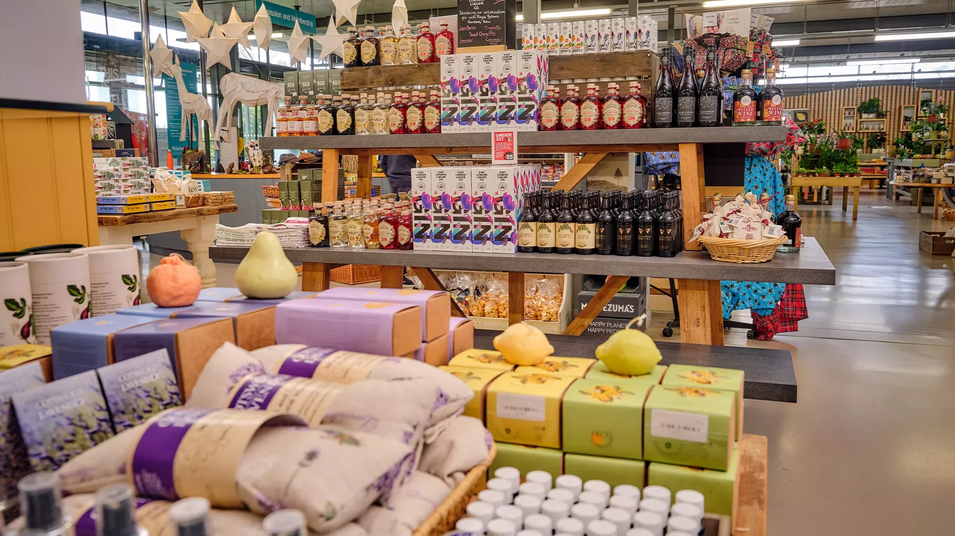 Retail at the Visitor Centre, Jim Holden © RBG Kew Shelves of products in the Wakehurst shop, including beauty products and drinks.