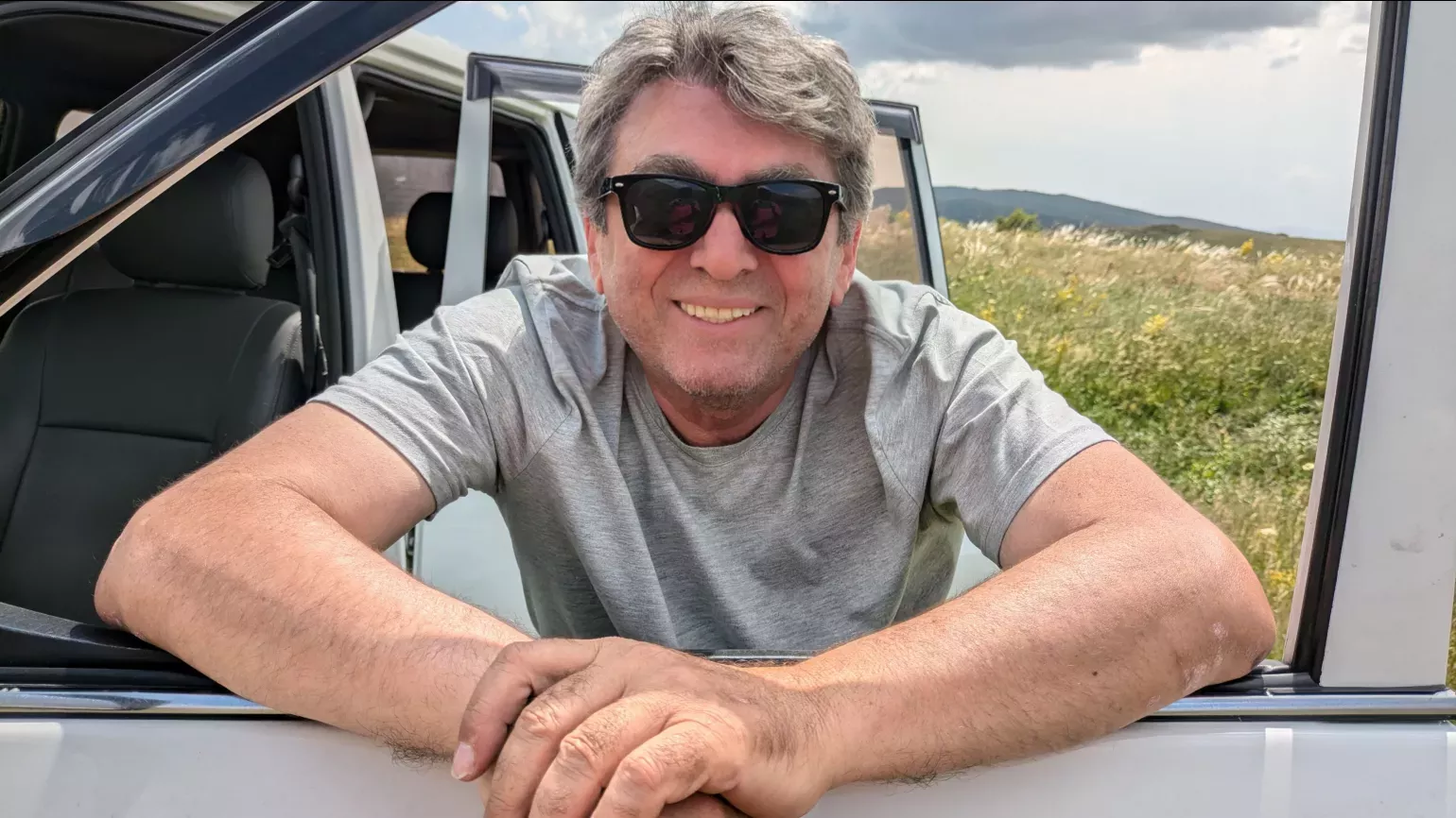 Drivers Aram and Edo ensured the team travelled safely through treacherous mountain passes with their impressive off-roading skills, Lydia Shellien-Walker © RBG Kew A person smiling through a car door window