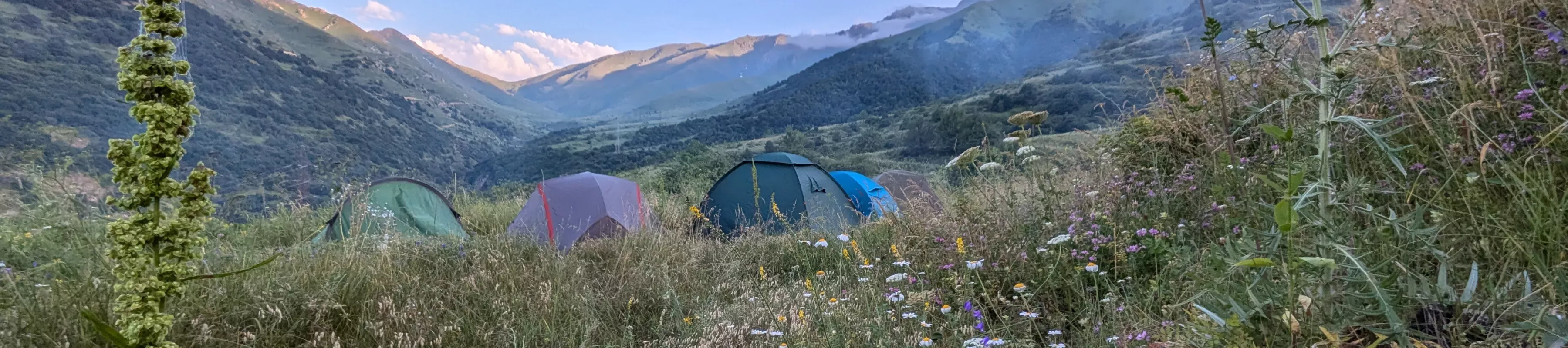 Camping in tents in a meadow in the Armenian mountains Camping in tents in a meadow in the Armenian mountains