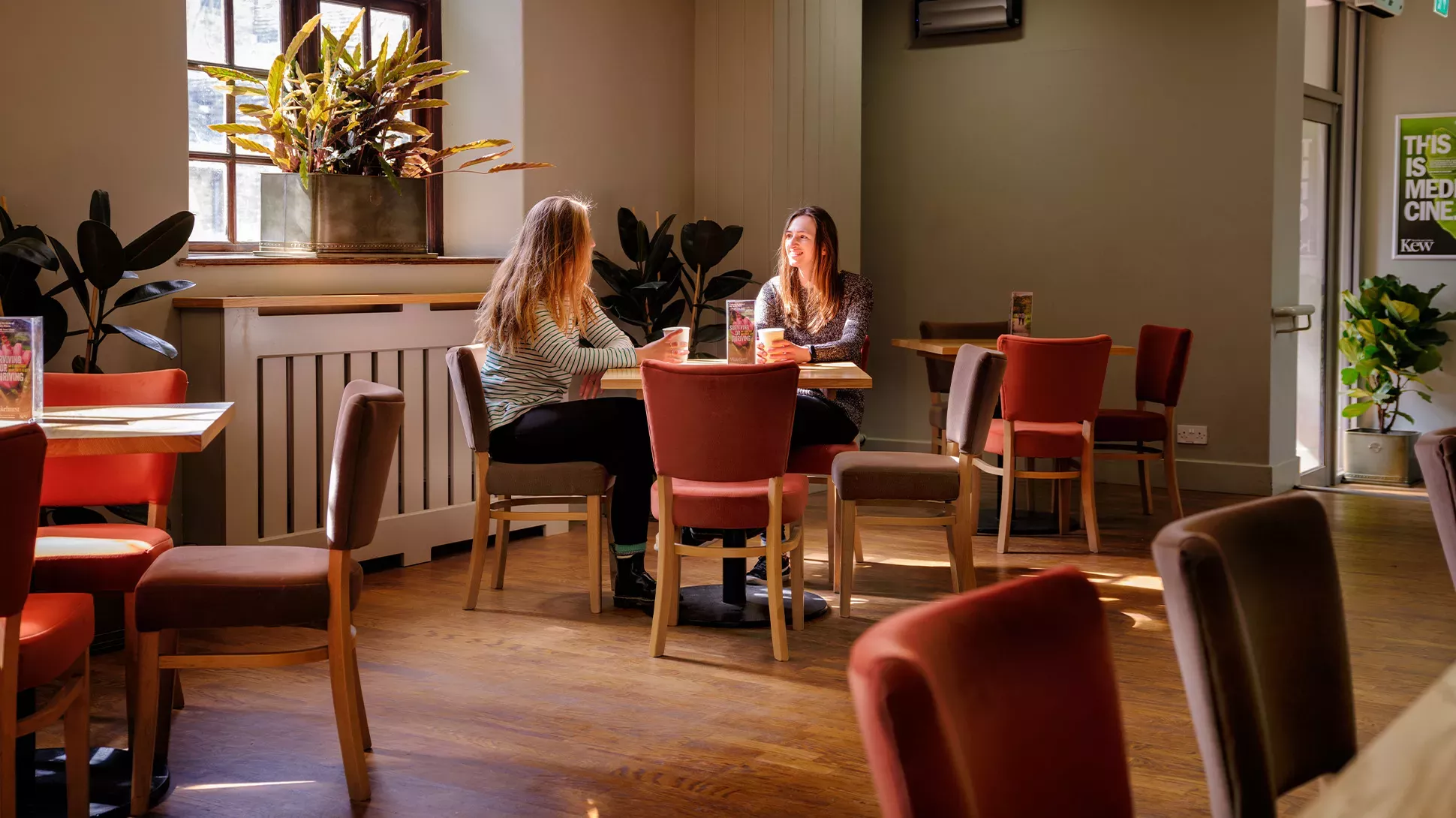 Stables Pantry, Jim Holden © RBG Kew Two women sit at a table in Stables Pantry cafe.