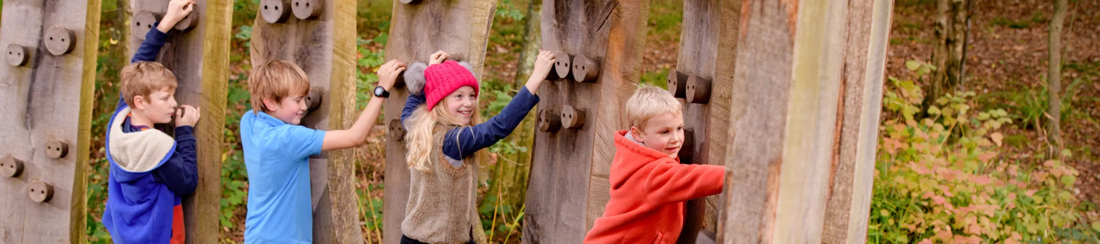 Tree Trunk Trek at Wakehurst, Jim Holden © RBG Kew Children climbing on wooden climbing frames