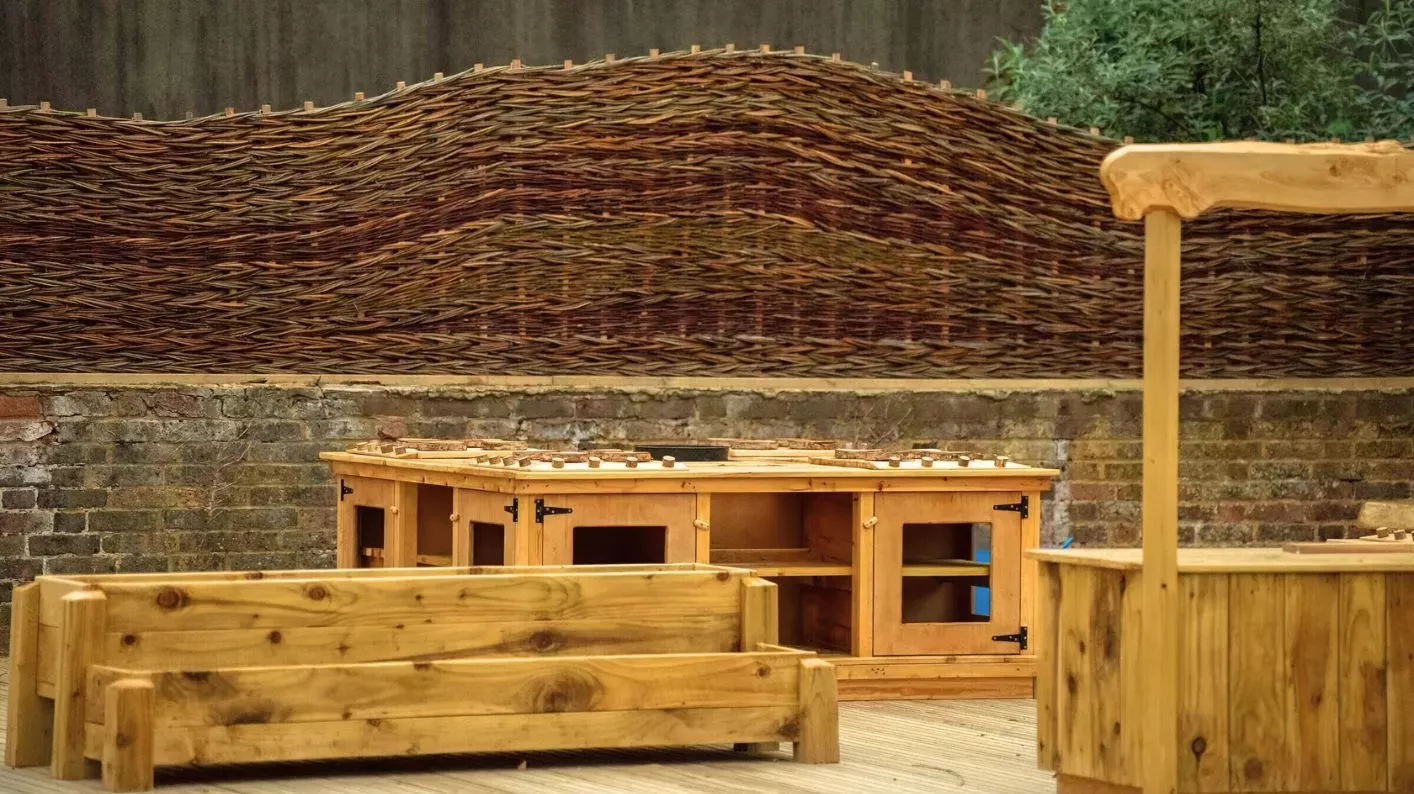 Children's & Community Garden, Visual Air © RBG Kew Wooden seating and toy cupboards in the Children's & Community Garden at Wakehurst