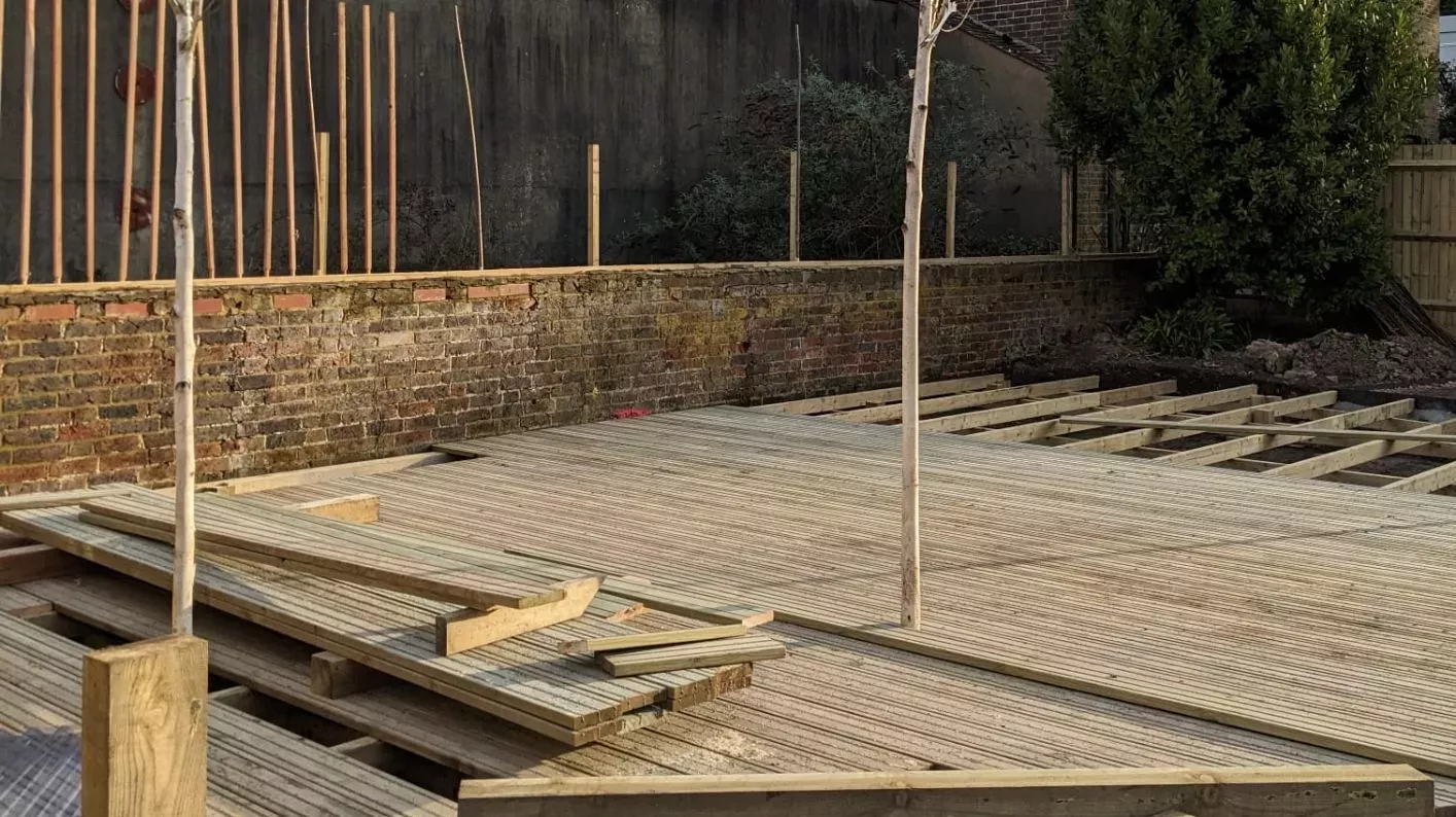 Wakehurst Children's & Community Garden © RBG Kew A work in progress of wooden decking being installed alongside a brick wal