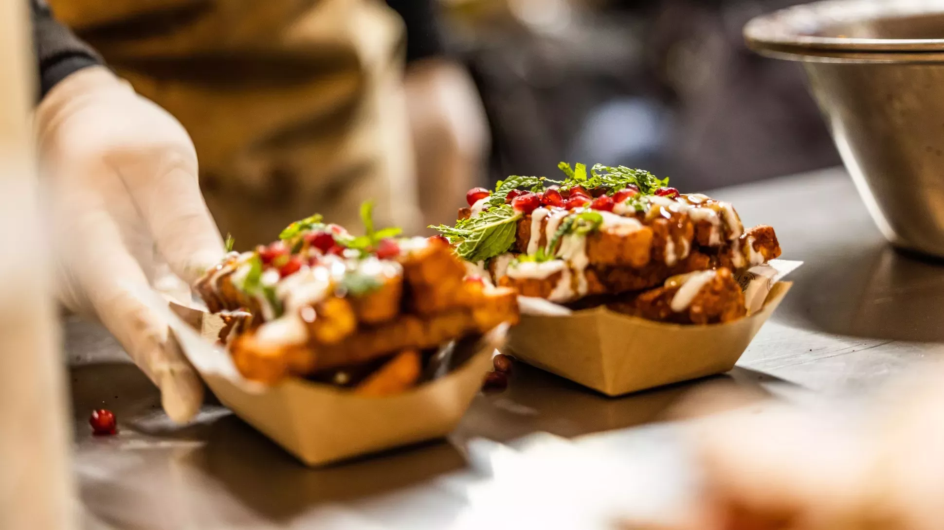 Halloumi fries at Christmas at Kew © KERB A pair of food trays containing garnished halloumi fries